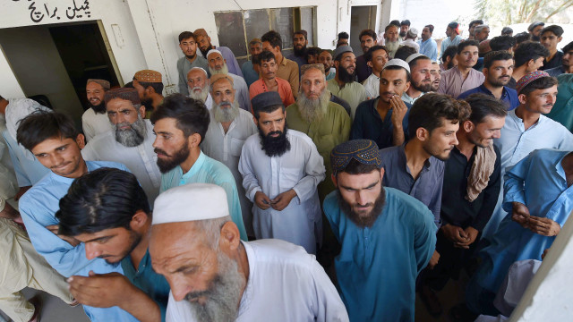 Afghan refugees line up at a holding camp for verification, in Karachi, Pakistan, 02 November 2023